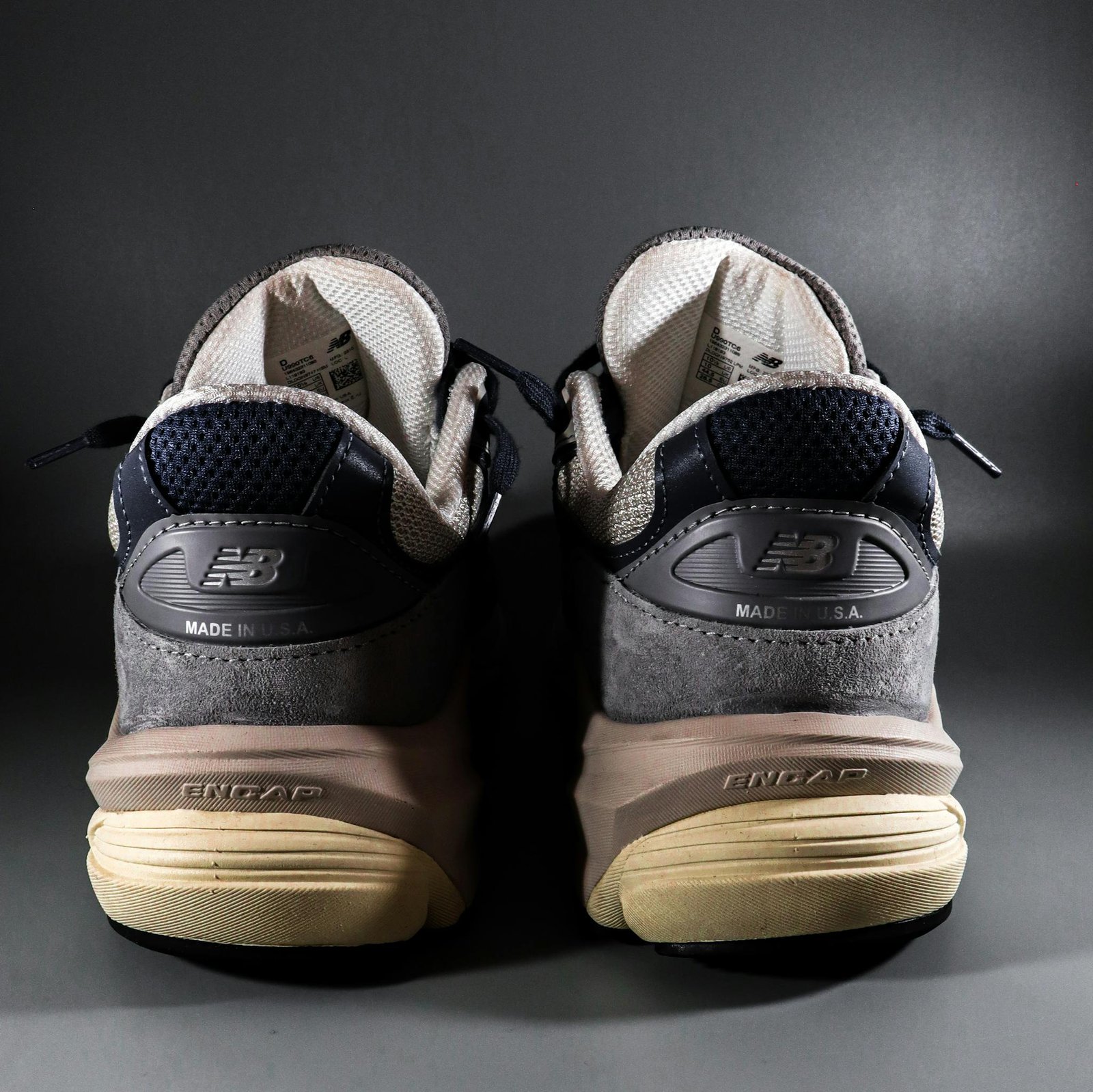 Close-up of New Balance sneakers showcasing details and branding with a focus on craftsmanship.